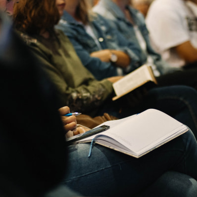 People following along in their Bibles during a service